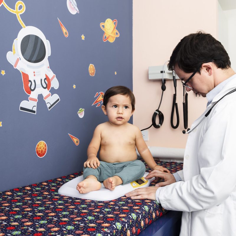 medium-shot-doctor-weighing-baby