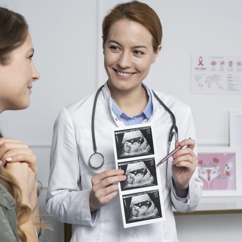 medium-shot-smiley-doctor-explaining-ultrasounds