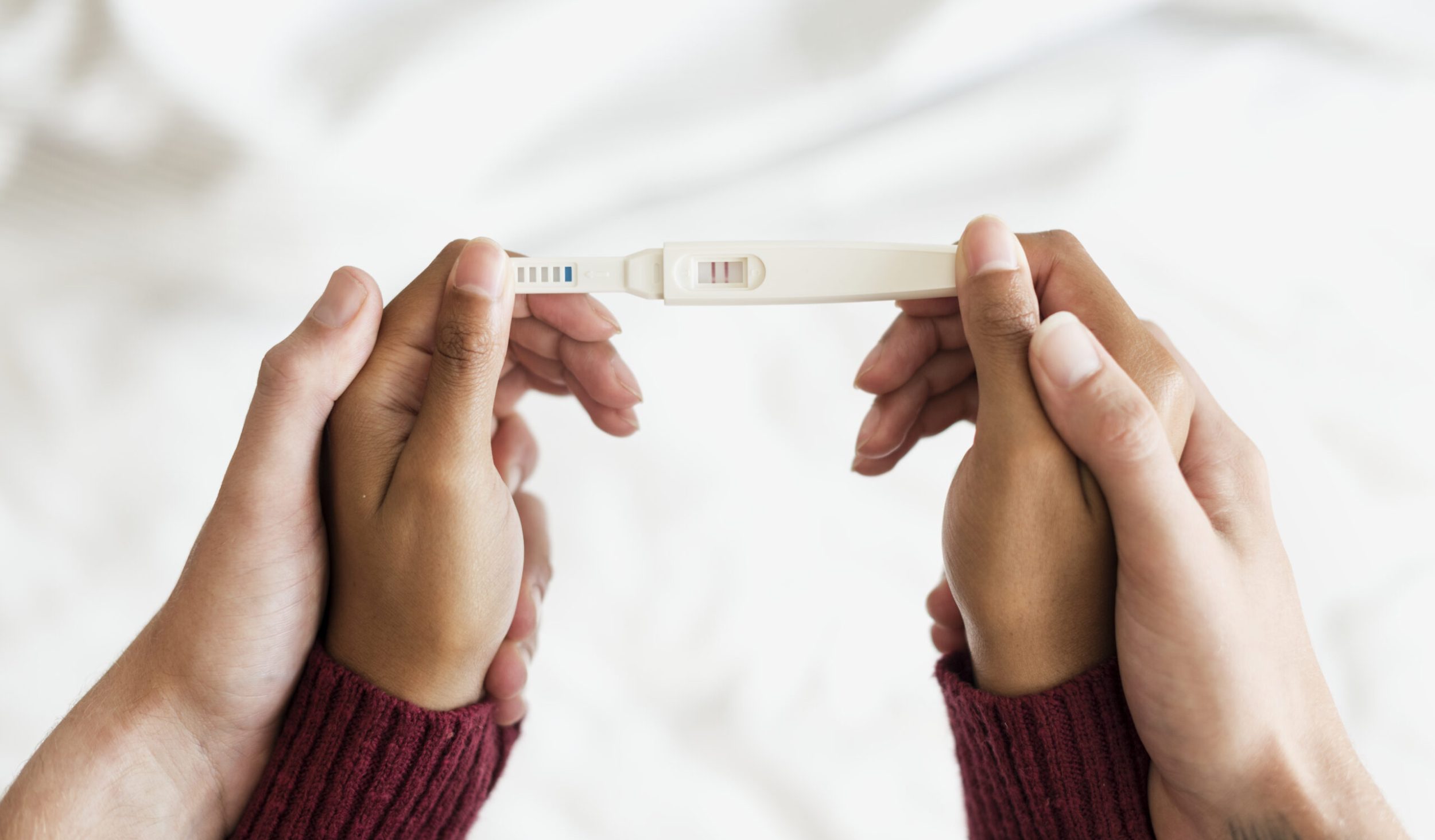 Woman holding a positive pregnancy test